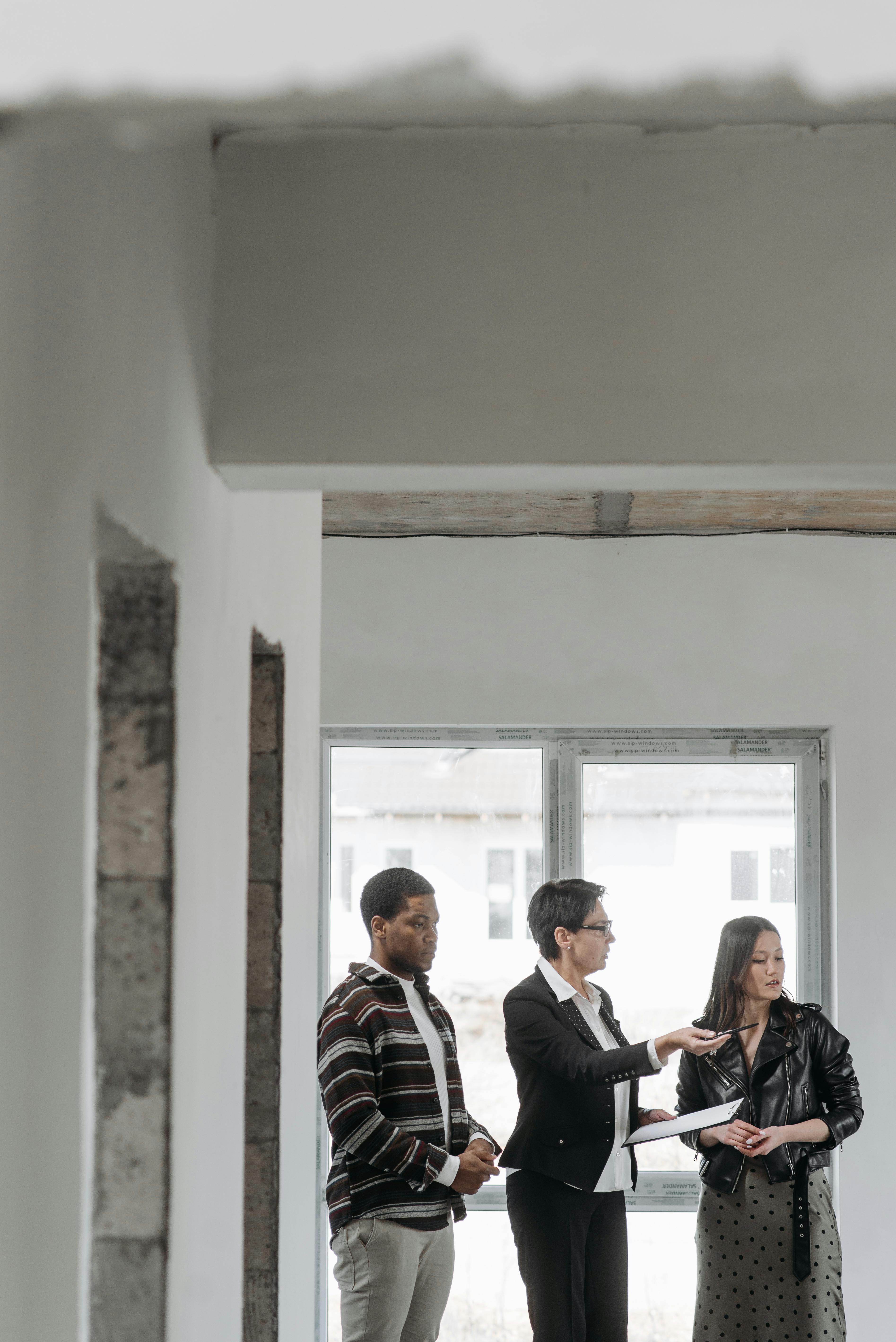 Real estate professionals discussing property details on site